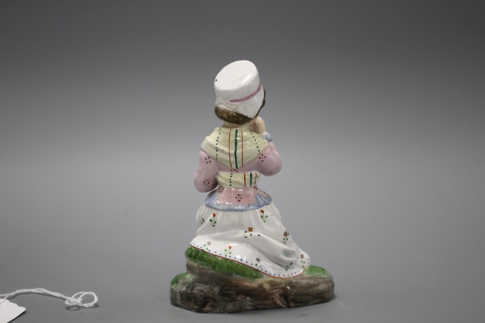 A 19th century Staffordshire figure of a seated young lady taking tea, height 13cm